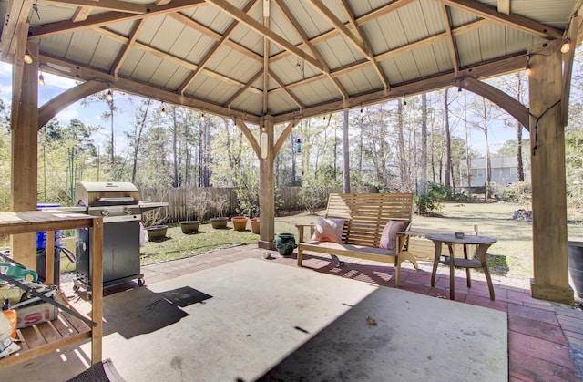 view of patio with fence, area for grilling, and a gazebo