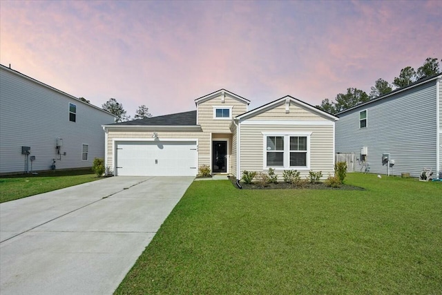 view of front facade featuring a garage, driveway, and a lawn