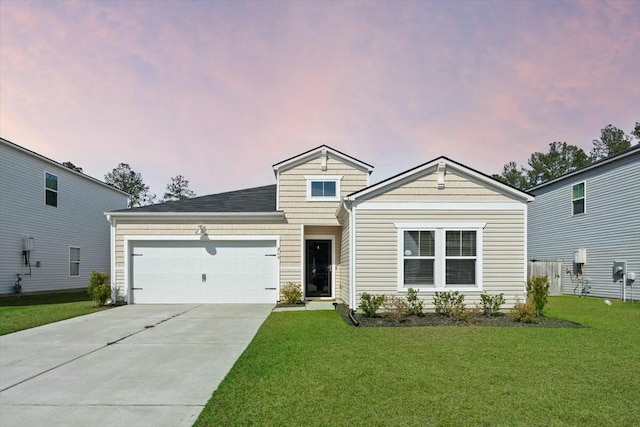 view of front of property with a garage, driveway, and a lawn