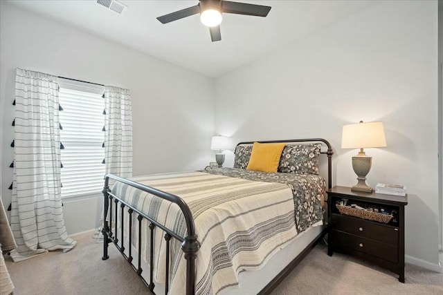 bedroom with carpet, visible vents, ceiling fan, and baseboards