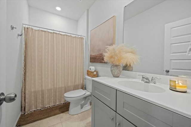 bathroom with a shower with curtain, vanity, toilet, and tile patterned floors