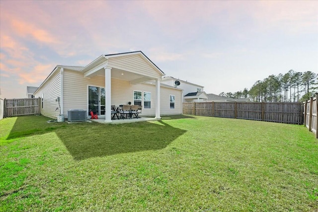 back of house featuring a patio area, a fenced backyard, a lawn, and central AC unit