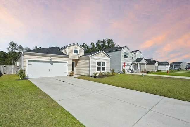 view of front of property with a garage, fence, concrete driveway, a lawn, and a residential view