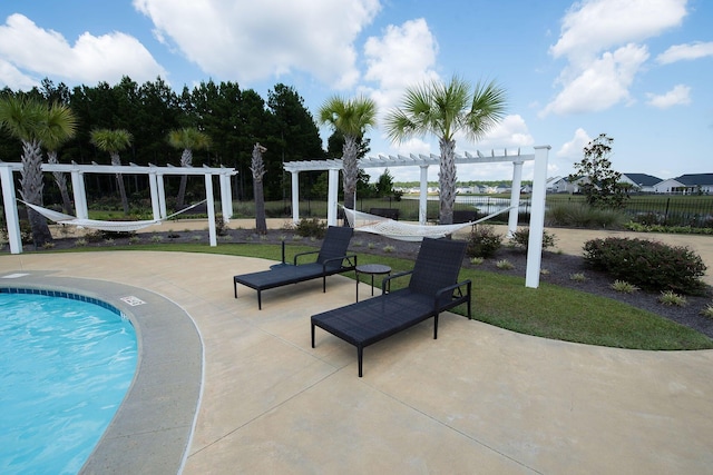 view of pool with a patio, fence, and a pergola