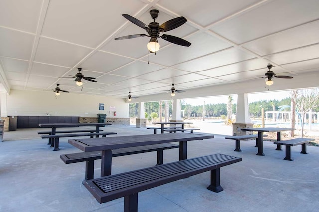 view of community featuring outdoor dining space and a patio