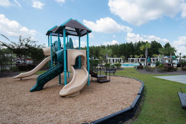 communal playground featuring a lawn and a community pool