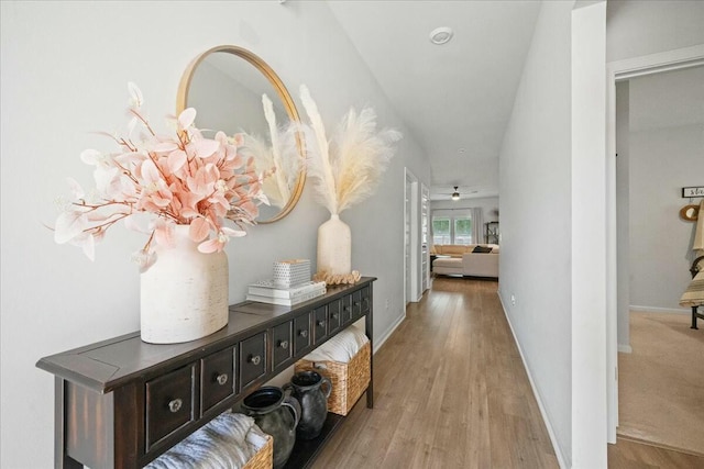 hall featuring wood finished floors and baseboards