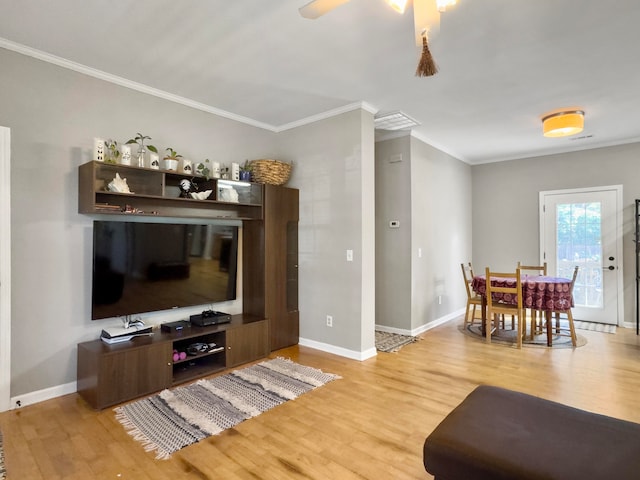 living room with ceiling fan, wood-type flooring, and ornamental molding