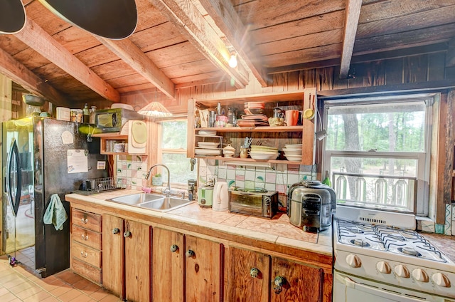 1373 Bridge St, Branchville, SC 29432 - kitchen with wood ceiling with exposed beams, a sink, white gas range, open shelves, and tile counters