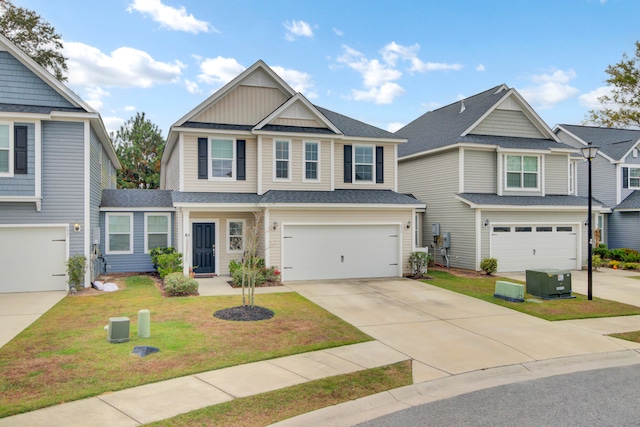 craftsman house featuring a garage, cooling unit, and a front yard