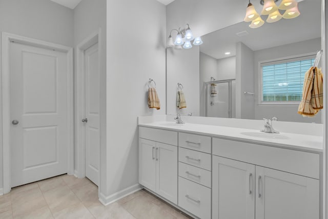 bathroom with tile patterned flooring, vanity, and a shower with door