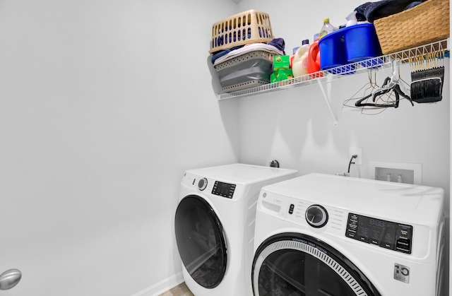 clothes washing area featuring independent washer and dryer