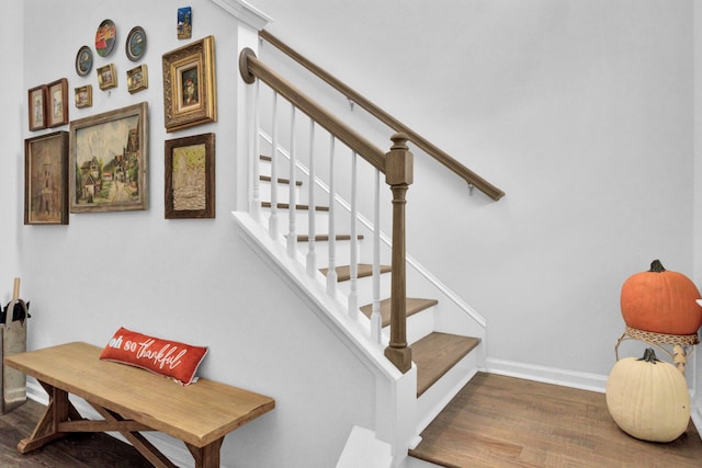 stairway with hardwood / wood-style floors