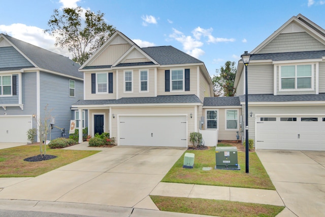 craftsman inspired home featuring a garage and a front lawn