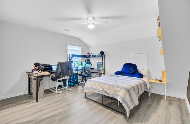 bedroom with wood-type flooring, ceiling fan, and vaulted ceiling