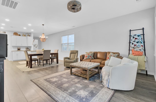 living room featuring hardwood / wood-style flooring and a notable chandelier