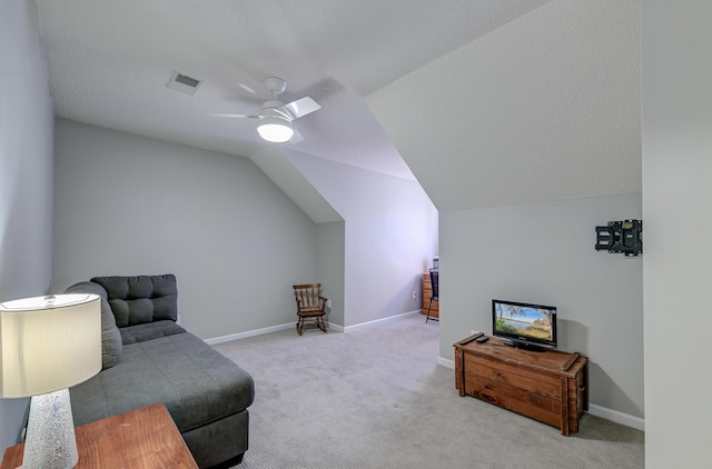 living area with carpet, lofted ceiling, visible vents, a ceiling fan, and baseboards