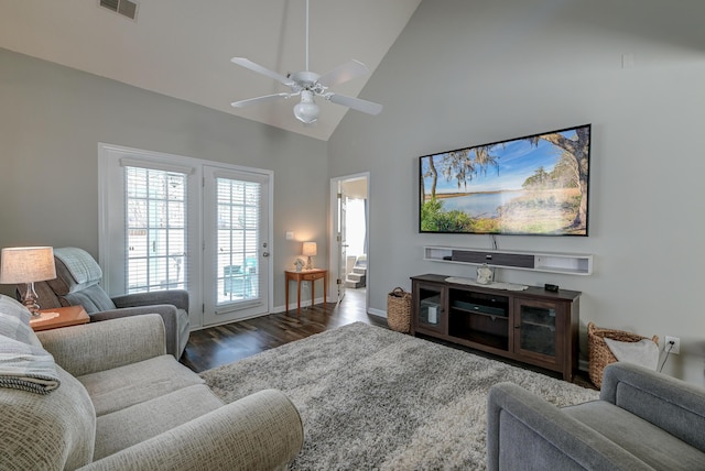 living room with ceiling fan, high vaulted ceiling, wood finished floors, visible vents, and baseboards