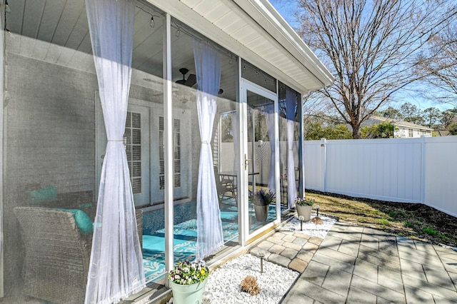 exterior space featuring a sunroom and a fenced backyard