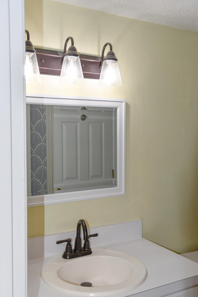 bathroom featuring vanity and a textured ceiling