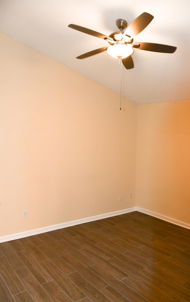 empty room featuring ceiling fan, dark hardwood / wood-style floors, and vaulted ceiling