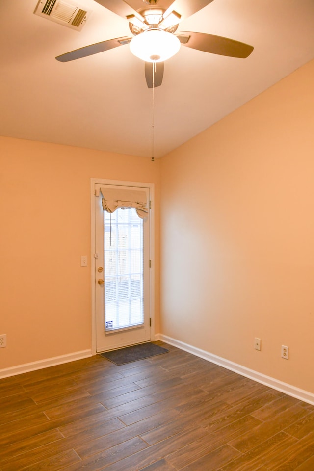 doorway featuring dark wood-type flooring and ceiling fan