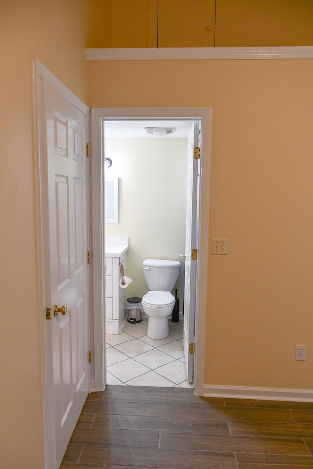 bathroom featuring wood-type flooring, vanity, and toilet