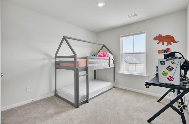 carpeted bedroom with baseboards and visible vents