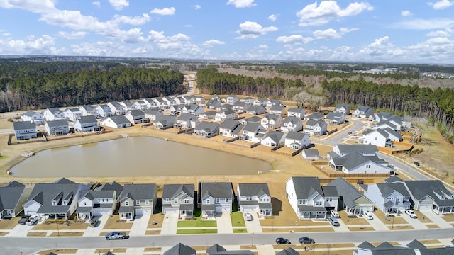 drone / aerial view with a water view and a residential view