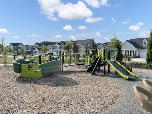 community playground with a residential view and fence