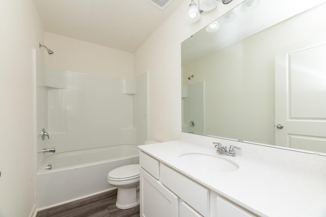 bathroom with visible vents, toilet, washtub / shower combination, vanity, and wood finished floors