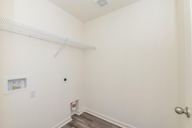 washroom with hookup for an electric dryer, laundry area, washer hookup, visible vents, and baseboards