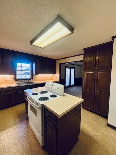 kitchen with a kitchen island, dark brown cabinets, sink, a textured ceiling, and electric stove