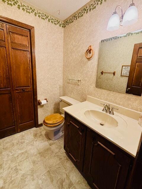 bathroom with toilet and vanity