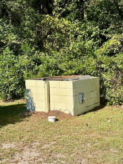 view of storm shelter with a yard