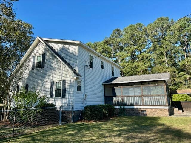 view of side of home featuring a yard