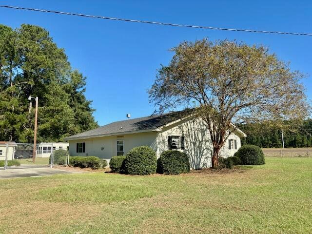 view of home's exterior with a lawn