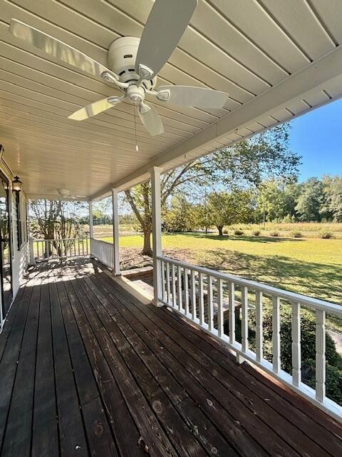 wooden terrace featuring ceiling fan