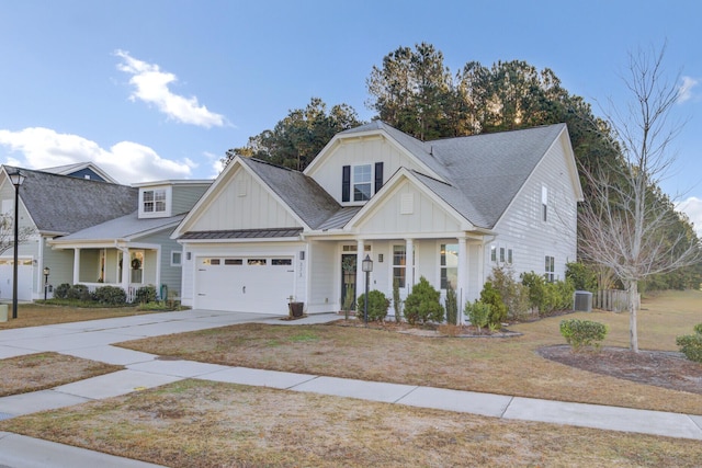 view of front of home with a porch, a garage, and central AC unit