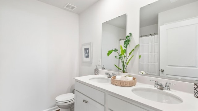 bathroom with toilet and vanity