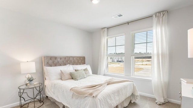 bedroom featuring light colored carpet