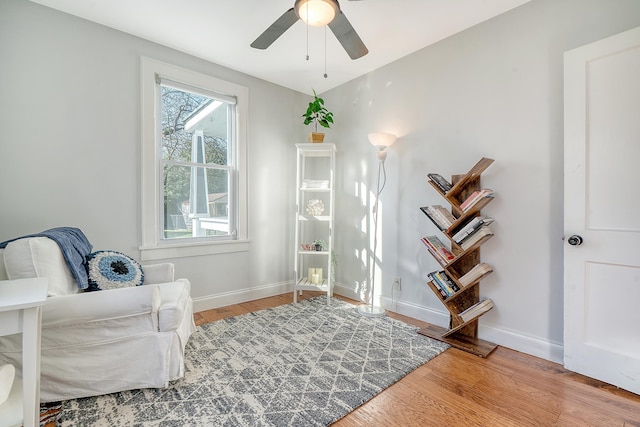 sitting room featuring ceiling fan and wood-type flooring