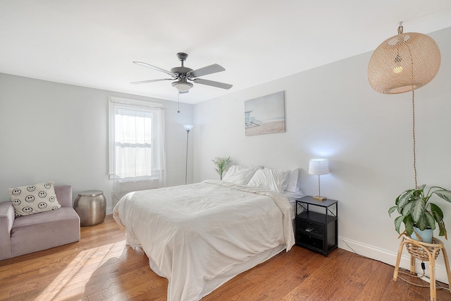 bedroom with hardwood / wood-style floors and ceiling fan