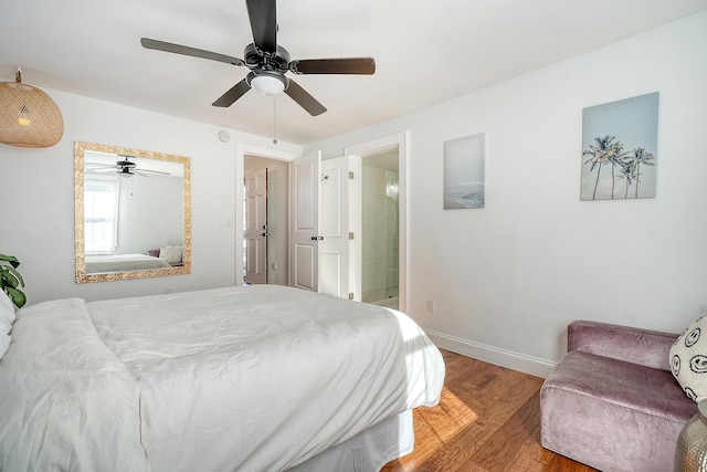 bedroom with ensuite bath, ceiling fan, and hardwood / wood-style floors