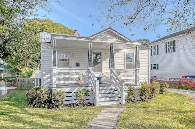 view of front of home with a porch and a front lawn