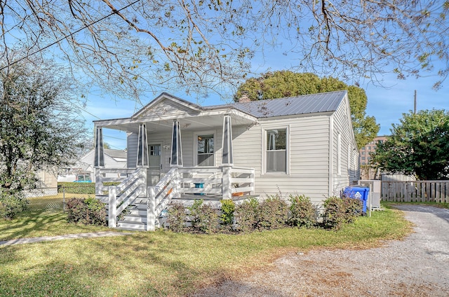 view of front of house with a porch and a front lawn