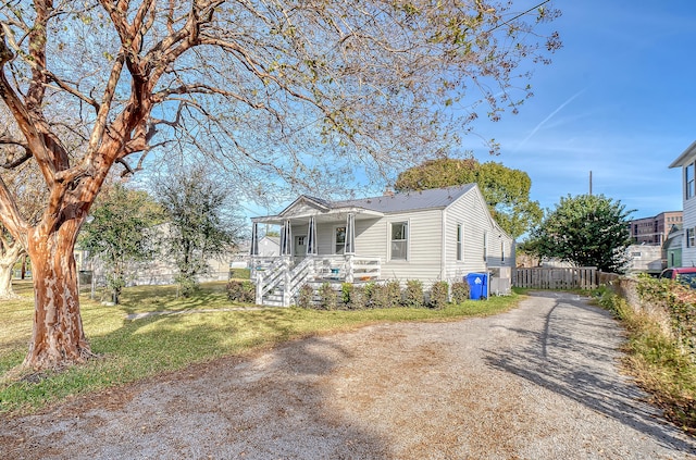 bungalow-style home featuring a front yard and a porch