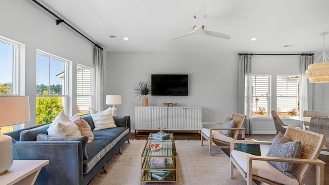 living room featuring plenty of natural light, baseboards, wood finished floors, and recessed lighting