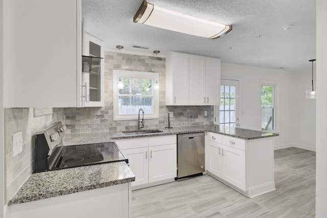 509 Hill St, Moncks Corner, SC 29461 - kitchen featuring appliances with stainless steel finishes, a sink, a peninsula, white cabinetry, and stone counters