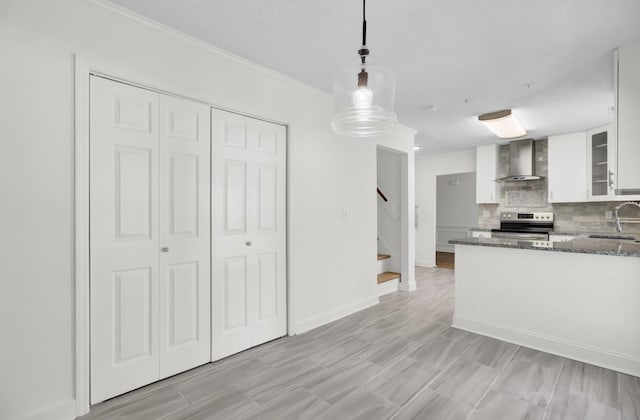 509 Hill St, Moncks Corner, SC 29461 - kitchen featuring wall chimney exhaust hood, stainless steel range with electric stovetop, white cabinets, tasteful backsplash, and dark stone countertops